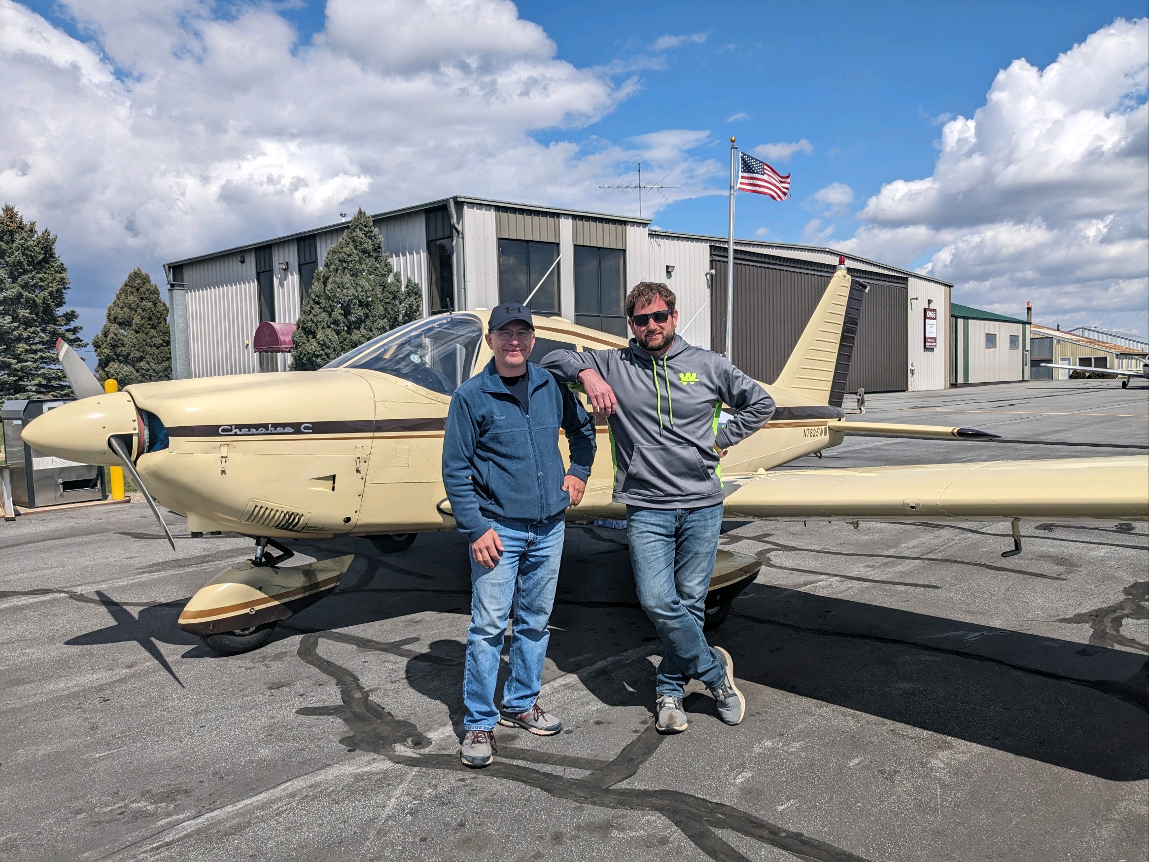 Flying Cloud Airport Flight instructor, Ron Hemmer (left) poses with his student pilot, Mike W after a successful checkride in a Cherokee 180 with DPE, Jim Shadduk